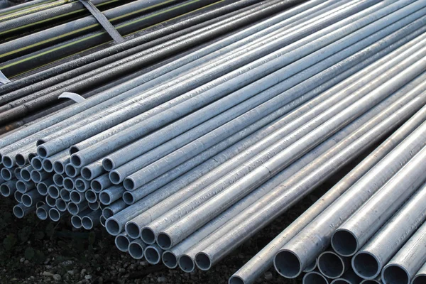 Pile of iron pipes for the transport of electrical cables and op — Stock Photo, Image