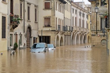 cars in the streets and roads submerged by the mud of the flood clipart
