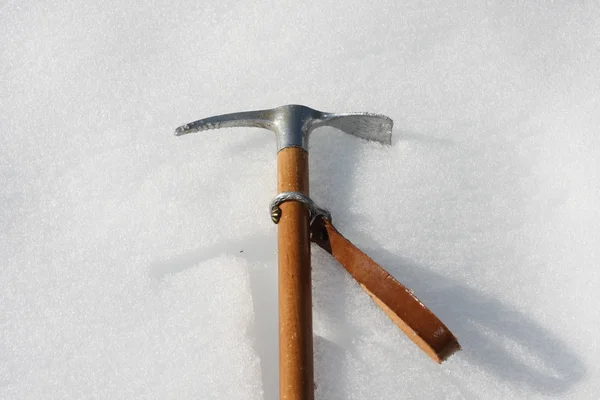 Toy axe in the cold snow in the mountains in winter — Stock Photo, Image