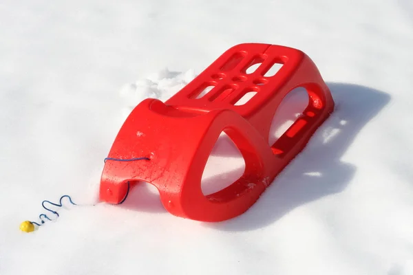 Plastic slide red used to play and to descend from the mountains — Stock Photo, Image