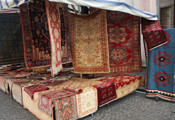 street big stall with resale of ancient Persian carpets