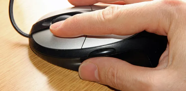 Hand of a young adult who click the left mouse button — Stock Photo, Image