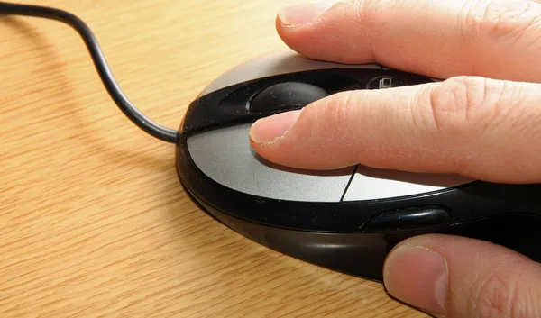 Hand of a young adult who click the left mouse button — Stock Photo, Image