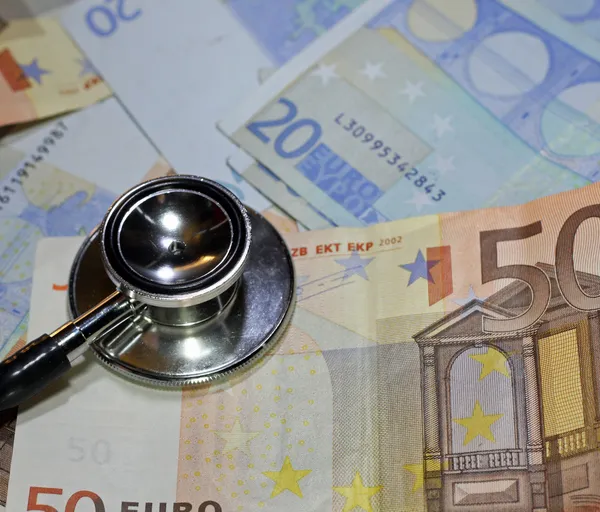 Stethoscope doctor leaned on many sick euro currency banknotes — Stock Photo, Image