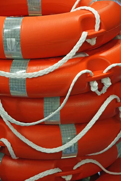 Piles of Orange life preserver for help to in danger of d — Stock Image Piles of Orange life preserver for help to in danger of d Stock Picture