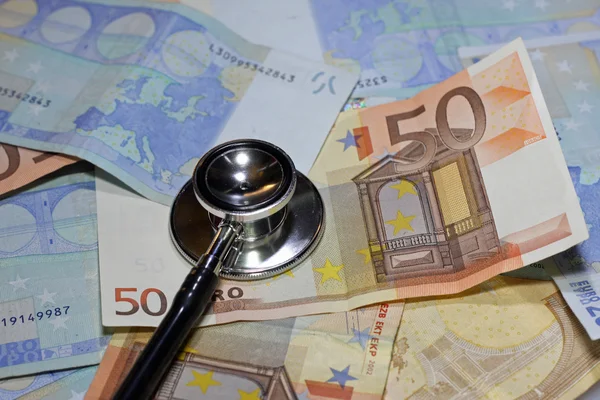 Stethoscope doctor leaned on many sick euro currency banknotes — Stock Photo, Image