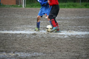 children players during a football match in a playing field full clipart