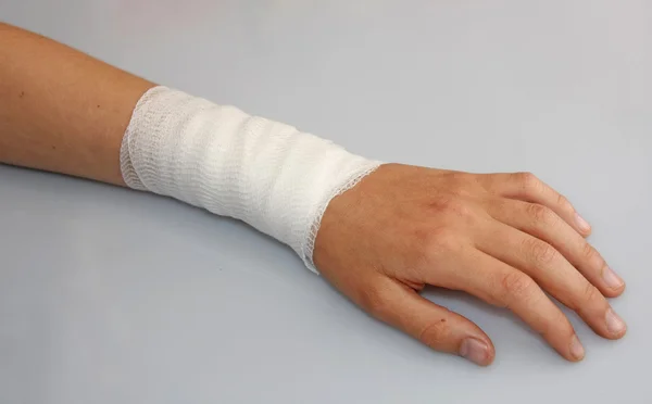 Bandaged arm of a child because of a skin lesion — Stock Photo, Image