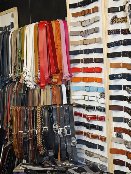 Many leather belts on sale at the local market in a stand — Stock Photo, Image