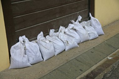 sandbags to protect against flooding of the River during the flo clipart