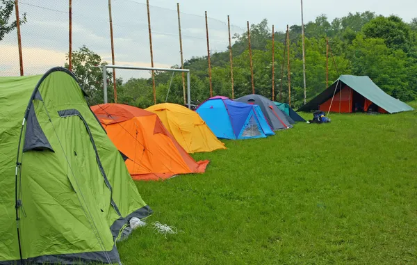 Acampamento com tendas olheiros campistas em um prado — Fotografia de Stock