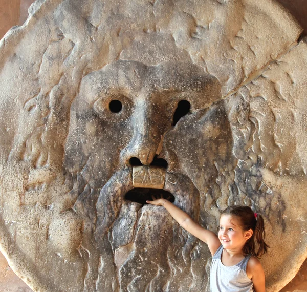 Girl puts her hand inside the mouth of truth in Rome — Stock Photo, Image