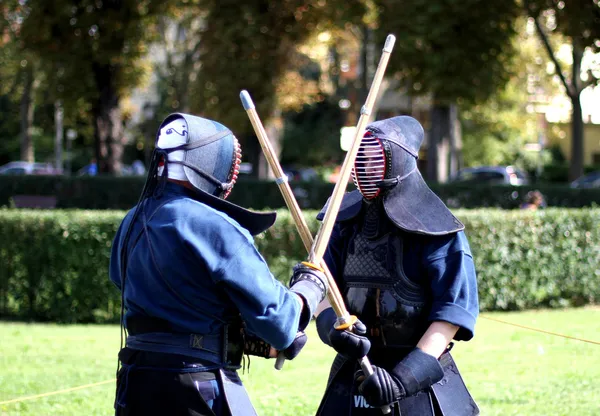 Fight between martial arts warriors with mask on face and the wo — Stock Photo, Image