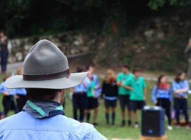 Chief scout with the typical Hat while controlling their kids to clipart