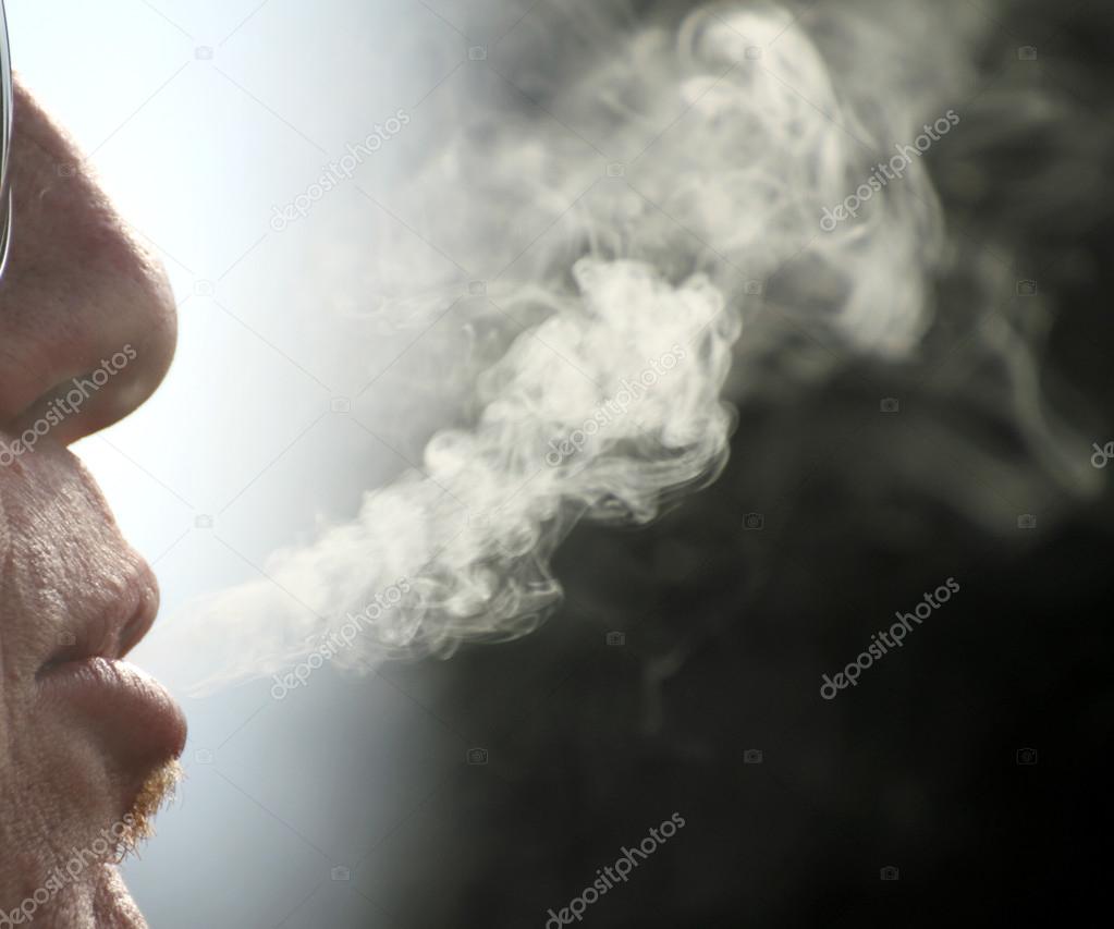backlit cigarette smoke and chain-smoker