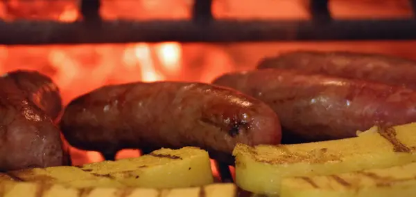 Barbecued sausage cooked in the fireplace — Stock Photo, Image