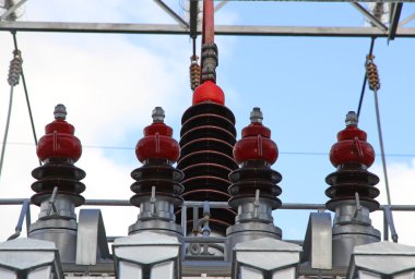 big insulators of a voltage transformer of a powerful power plan clipart