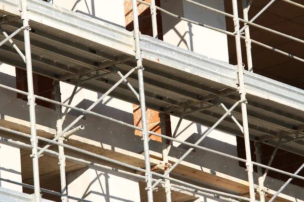 Scaffold building for the construction of buildings in the immen — Stock Photo, Image