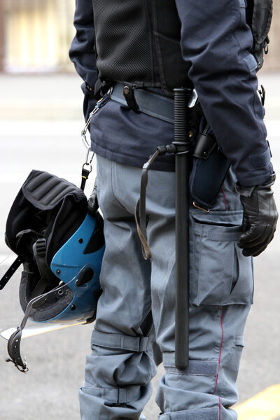 Policeman with truncheon, helmet gun and handcuffs