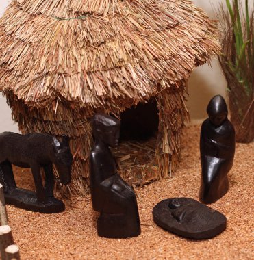 Nativity set in an village with wooden figurines 2 clipart