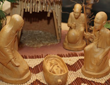 Nativity set in an village with wooden figurines 1 clipart