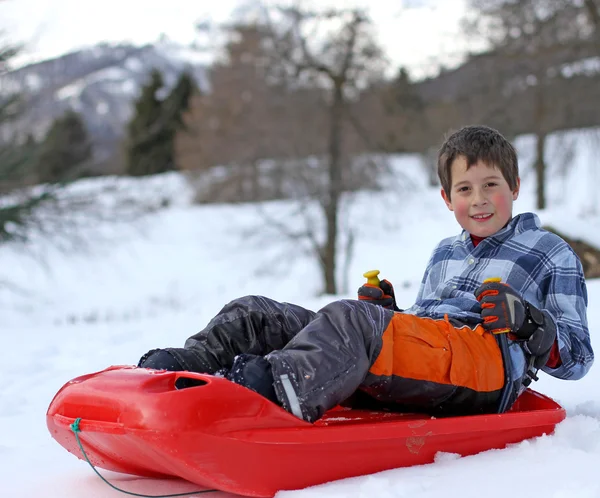 Little boy playing with the bob on snowy mountain — Stock Photo, Image