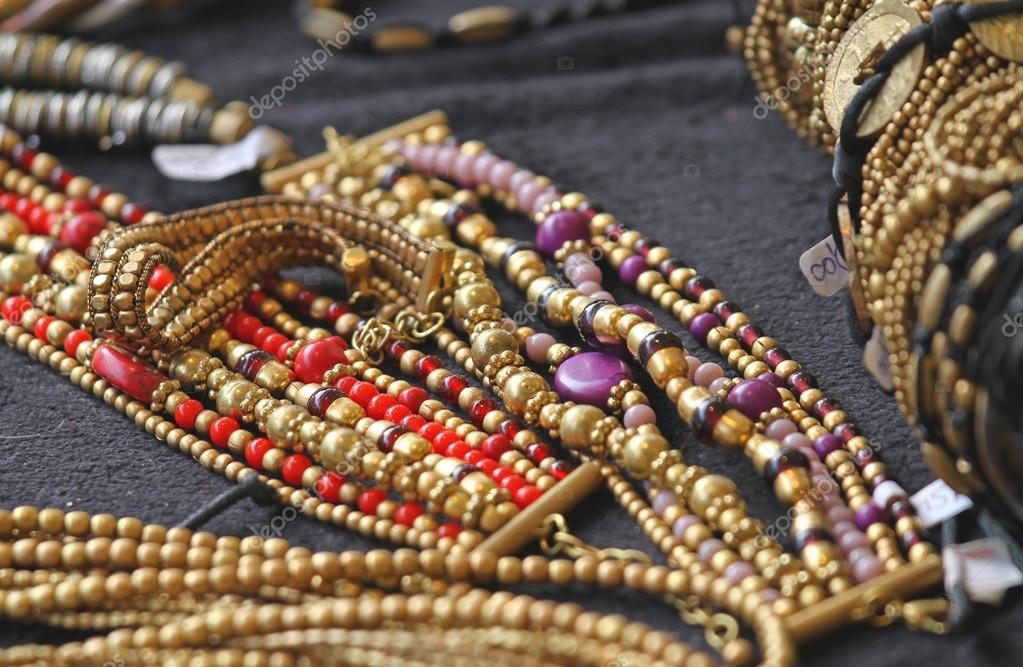 Ancient gold jewelry and precious jewels for sale Stock Photo by ©ChiccoDodiFC 42408379