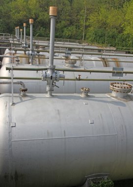 tops of the tanks with exhaust valves for storage of natural gas clipart