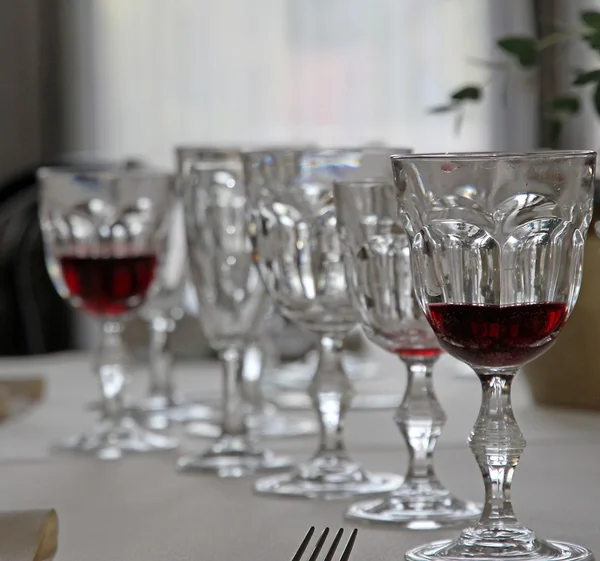 Bohemian crystal glasses lined up in set table — Stock Photo, Image