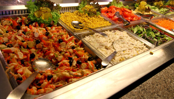 steel trays with many delicious foods in a self-service restaura