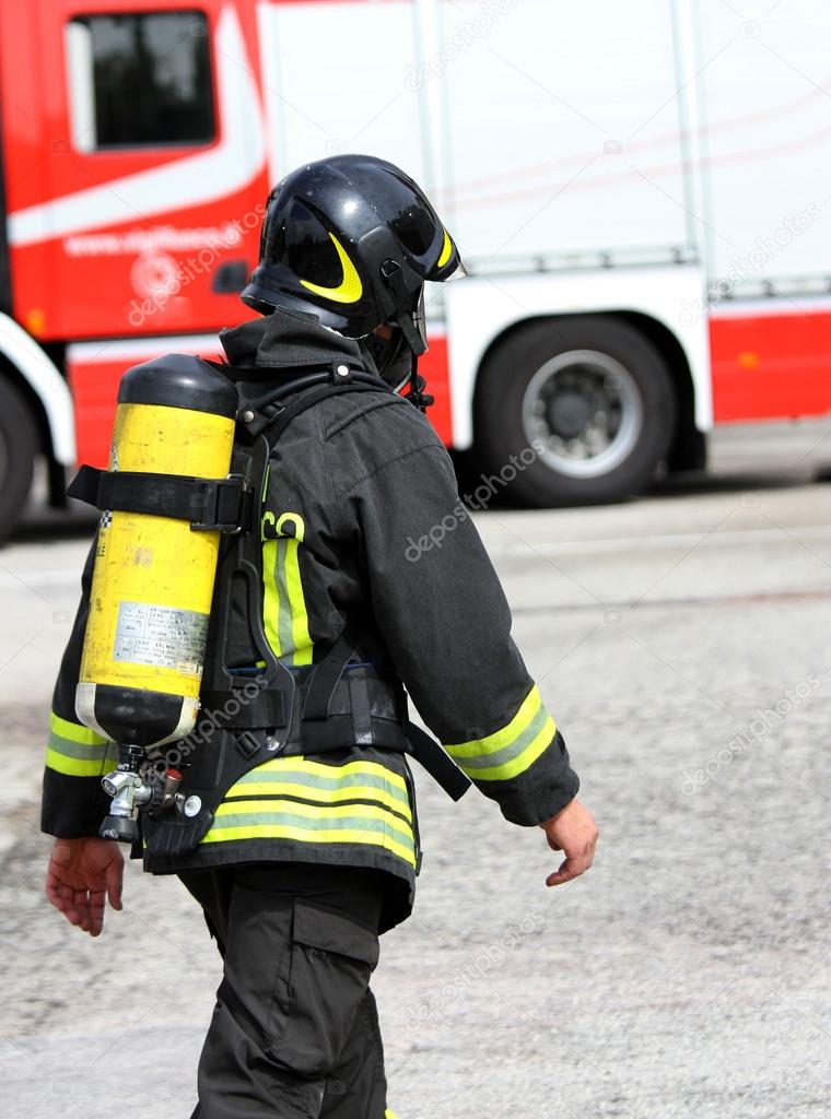 Italian firefighter with the oxygen cylinder and the helmet