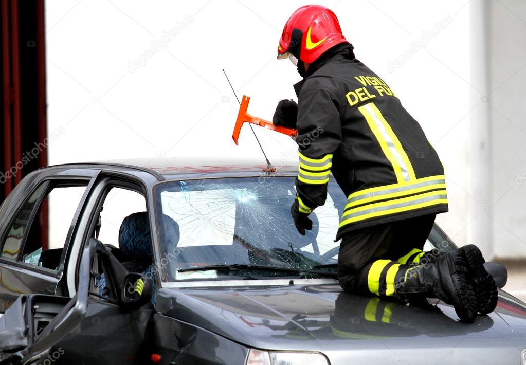 Fire Chief breaks the windshield of the car with a hammer
