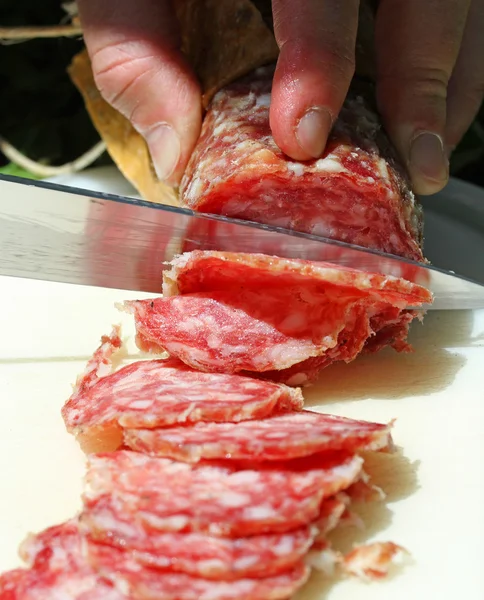 SALAMI with steel knife that cuts 4 — Stock Photo, Image
