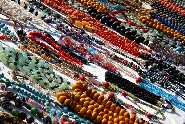 Many necklaces illuminated by the Sun necklace for sale at flea — Stock Photo, Image