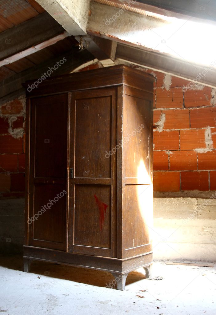 emblematic wooden wardrobe in a dusty attic of a nursery