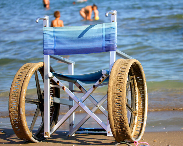wheelchair with perforated wheels on the Sea Beach