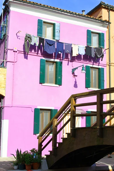 Pink colored House on the island of Burano with clothes hung out