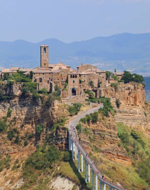 İtalya 'nın merkezinde Civita di Bagnoregio adında bir köy ve evlerin olduğu tepeye ulaşmak için uzun bir köprü.