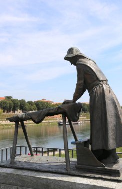 Pavia, PV, İtalya - 28 Ağustos 2015: Ticino Nehri 'nde zengin vatandaşların çamaşırlarını yıkayan çamaşırcı kadınların anısına bronz heykel
