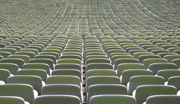 many green seats in a sports facility without people