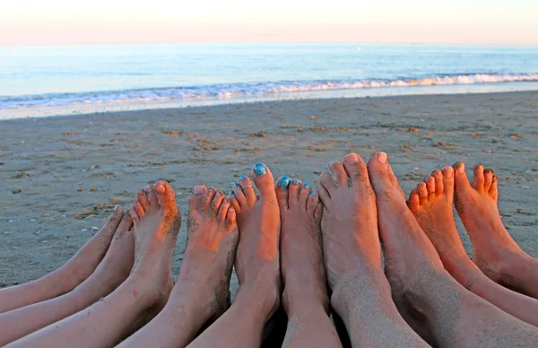 Feet of a family in the seaside resort on the Sea Beach — Stock Photo, Image