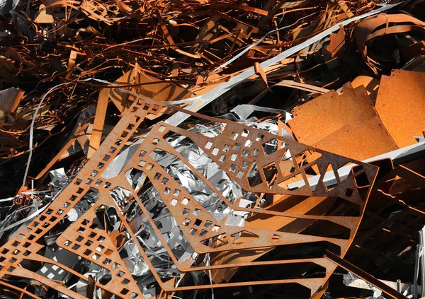 pile of rusty pieces of iron in the recycling center for the recovery of metal material for recycling