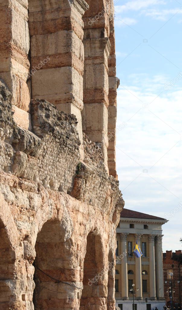 detail of the arcades of the ancient Arena an amphitheater from the Roman era and the town hall in the background in the city of Verona in northern Italy in the Veneto region