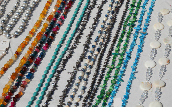 many necklaces made with leather for sale in the stall of handmade products