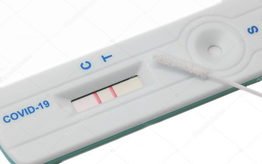 nasal swab and the rapid test kit for the diagnosis of coronavirus with two lines positive symptom