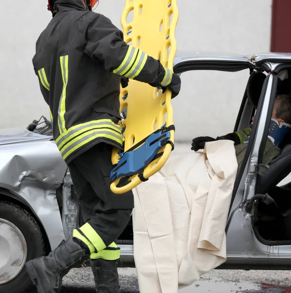 Firefighter Action Yellow Stretcher Road Accident Transport Injured Person Who — Stock Photo, Image