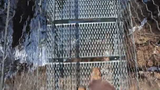 Hiker Walking Suspended Steel Rope Bridge — стоковое видео