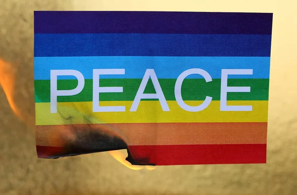 Multicolored Flag Text Peace While Burning Flame Symbol Destruction War — Stock Photo, Image