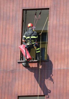 climber firefighter go in the house by window during emergency