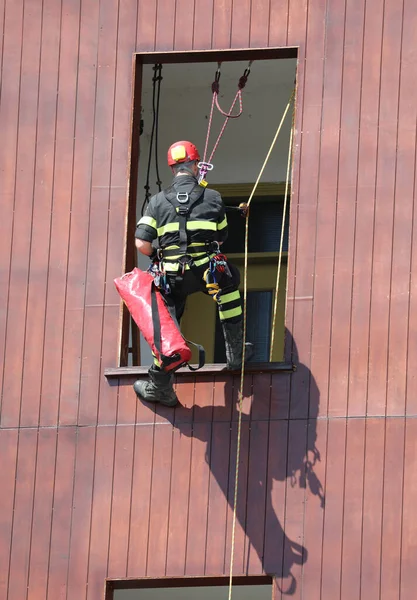 climber firefighter go in the house by window during emergency